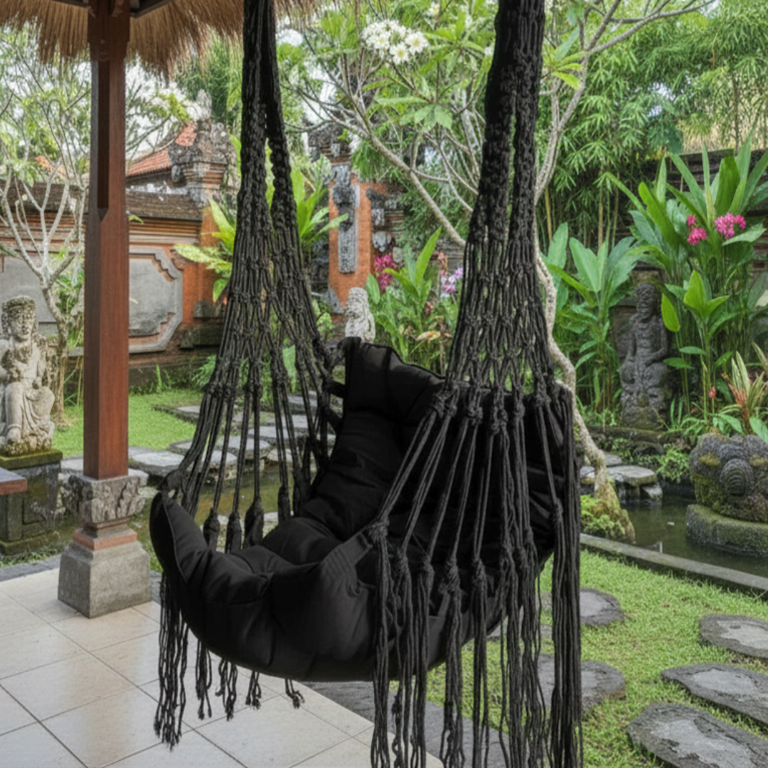 boho macrame swing chair in Black cotton finish in a balinese style garden 