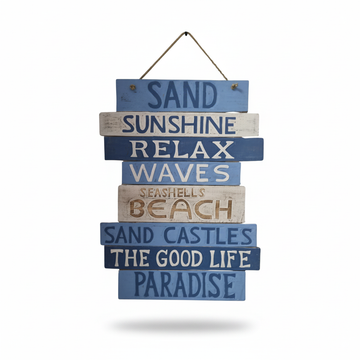 A rustic stacked wooden sign with blue, navy, and whitewashed planks reading 'Sand Sunshine Relax Waves Seashells Beach Sand Castles The Good Life Paradise' on a white background.