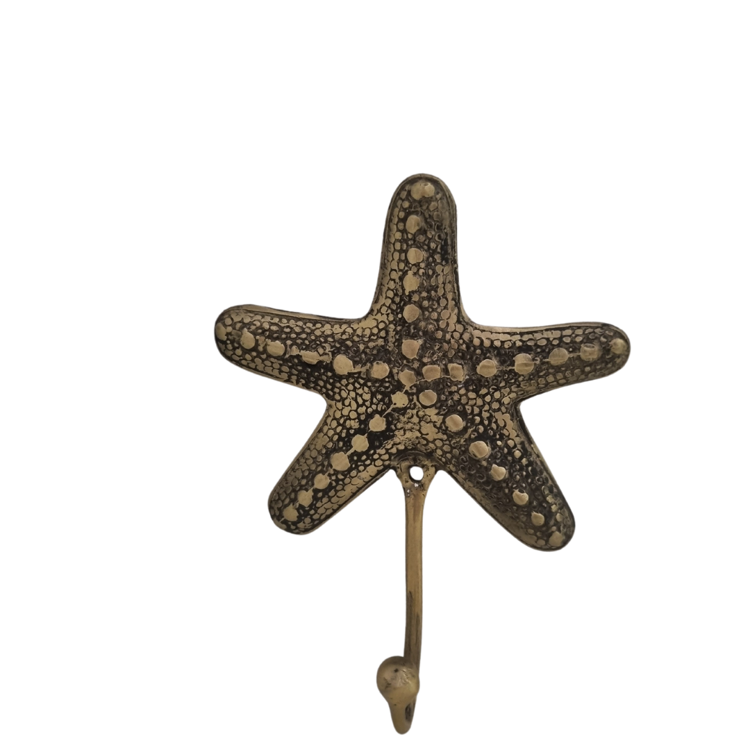 Brass starfish wall hook front view showing detailed dot texture and antique finish on white background