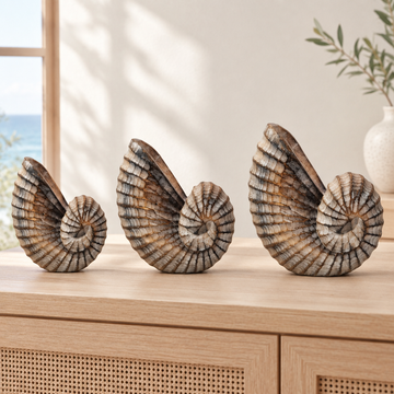 Three graduated brown-wash spiral carvings displayed on a pale timber console