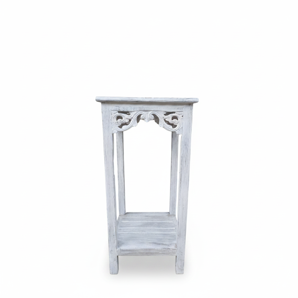 A small white distressed wooden side table with an open lower shelf and decorative carved details on the upper frame, shown against a plain white background.