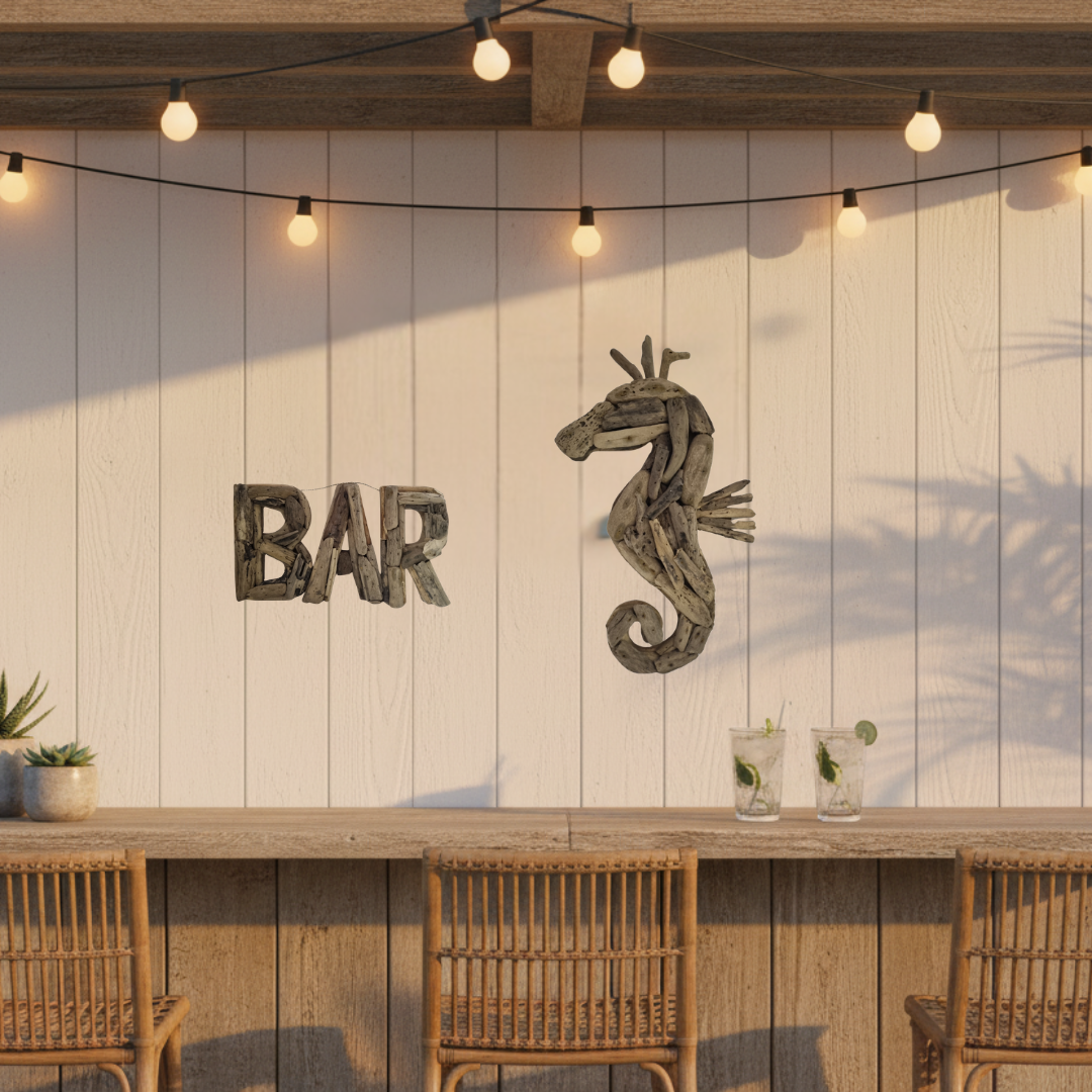 Rustic bar wall decor featuring a weathered wooden 'BAR' sign and a seahorse sculpture mounted on a white wood-paneled wall, above a wooden counter with woven chairs and hanging string lights.