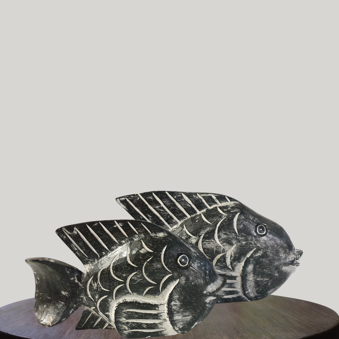 Decorative fish sculpture on a round wooden platform with a plain background