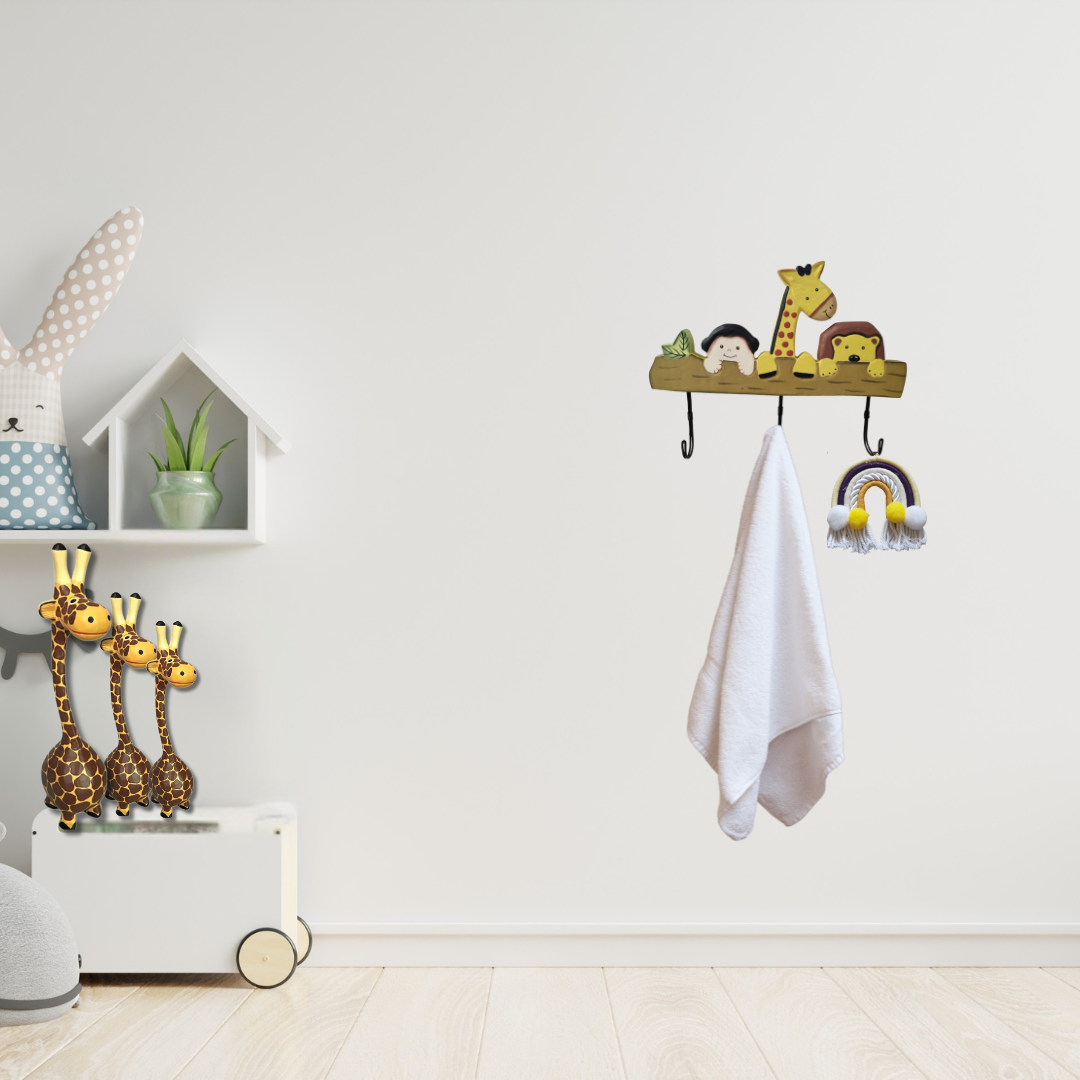 Children's room with shelves, toys, and a towel on hooks against a white wall.