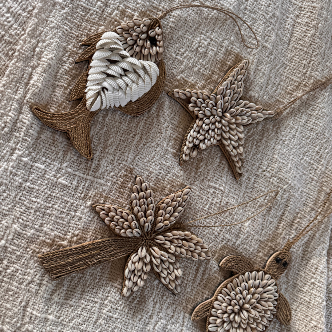 Decorative elements including a fish, starfish, and turtle on a textured fabric background