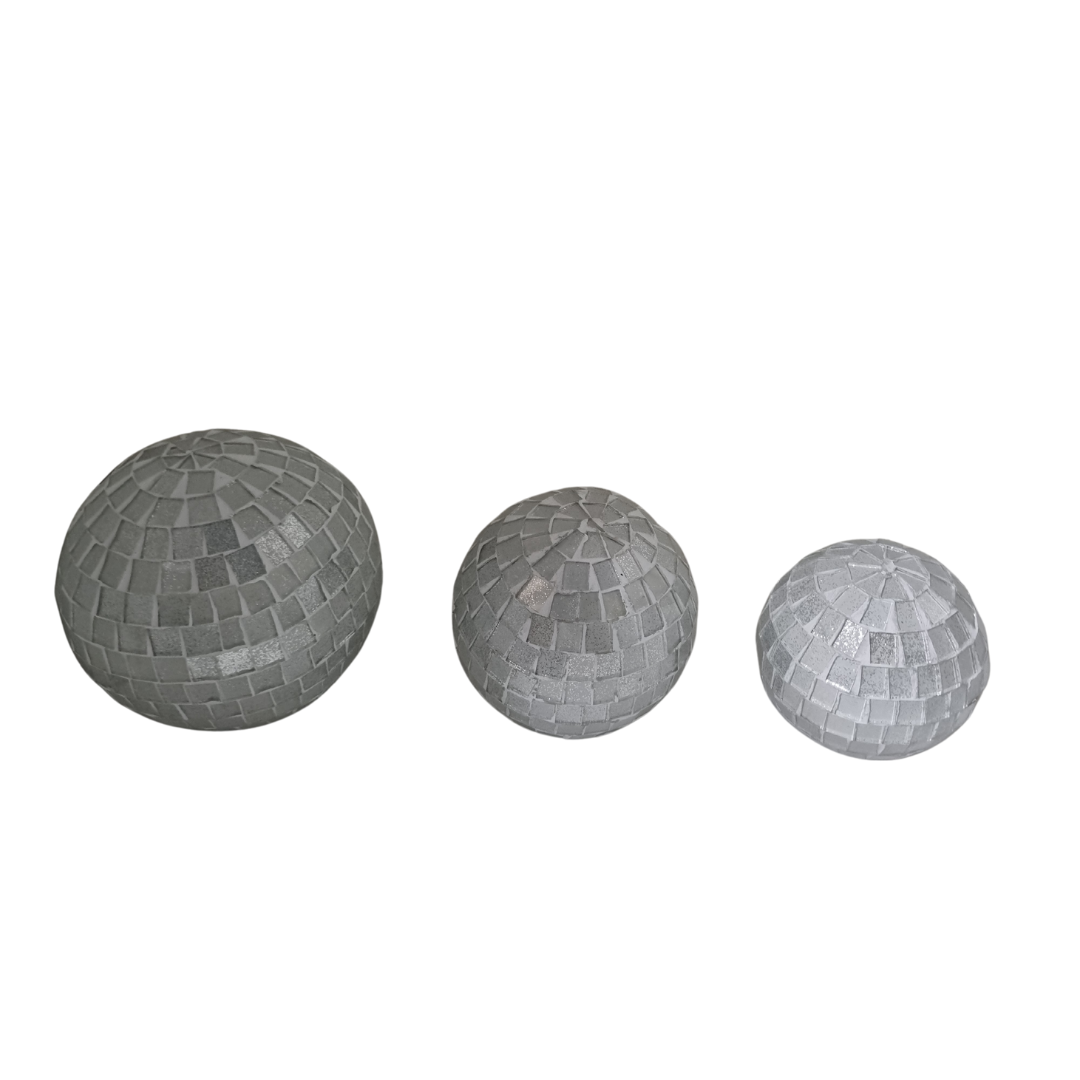 Three mosaic decorative balls in white, each with a geometric pattern made of small tiles