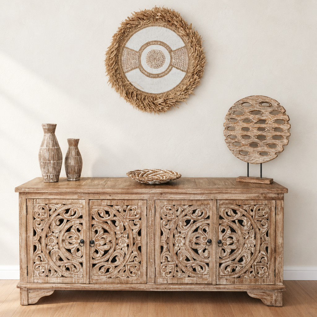 natural tone circular hanging above a carved timber cabinet on a soft white wall
