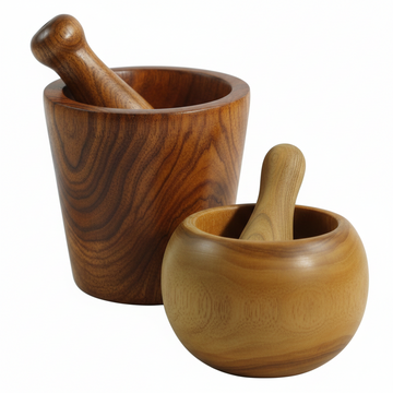 Pestle and mortar wooden kitchen tools — two handcrafted teak wood sets with pestles, showing contrasting dark and light natural grain tones on a white background
