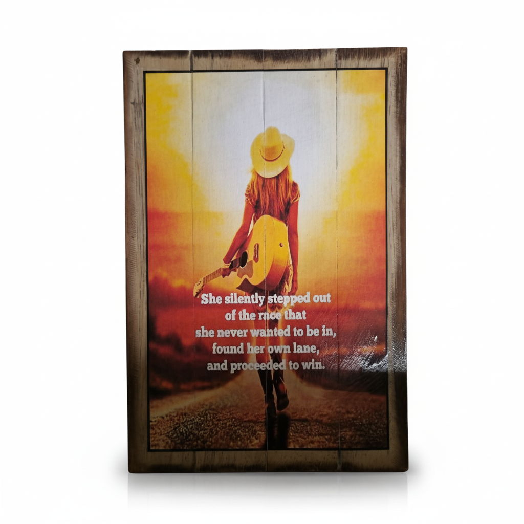 A rustic wooden sign featuring a photo of a woman in a cowboy hat holding an acoustic guitar against a warm sunset background, with white text overlay and a dark wood border.