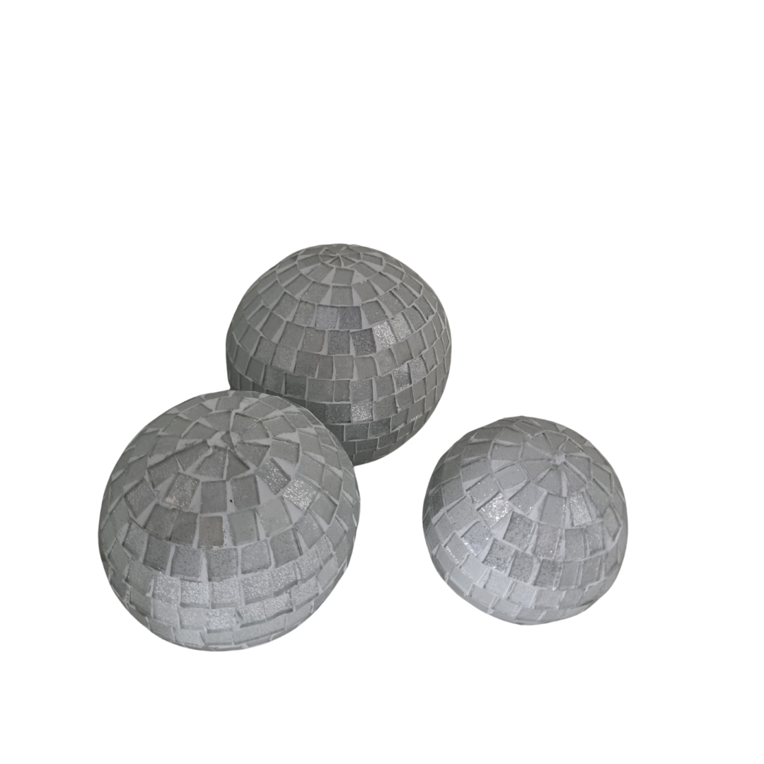 Three mosaic decorative balls in white, each with a geometric pattern made of small tiles.
