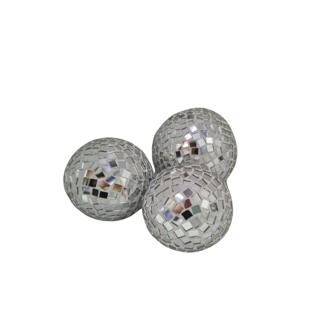 Three silver disco balls on a white background