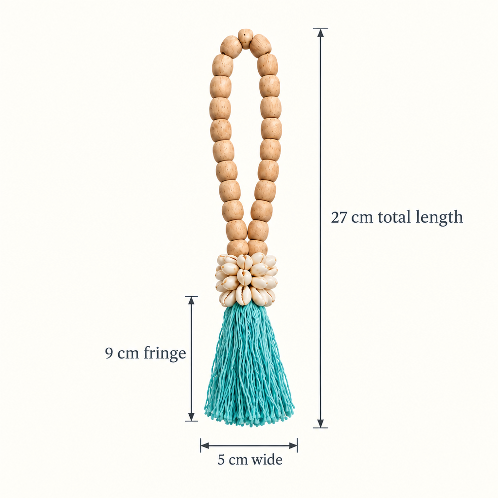 Turquoise cotton strands with cowrie shells and a wooden loop, with arrows showing 27 cm long and 5 cm wide  cotton 9cm long.
