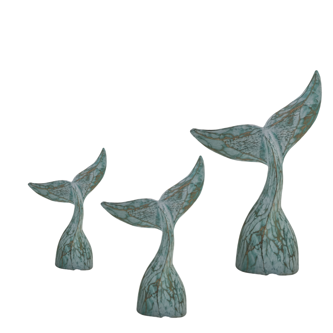 set of three turquoise whale tails from small medium and large sizes on a white back ground 