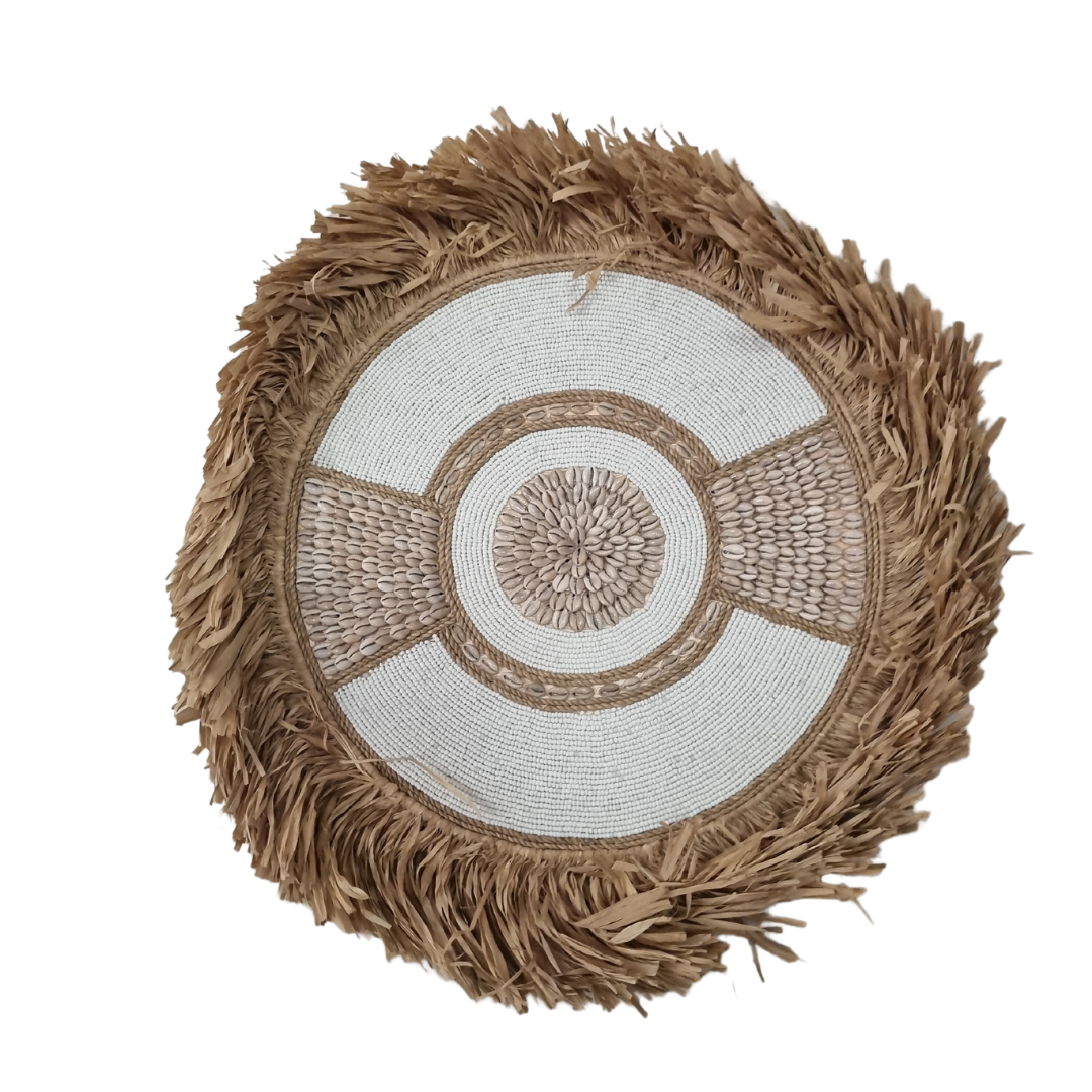 circular boho style wall art pieces made of seagrass with beads and shells, in natural beige and white colors, displayed against a white background.
