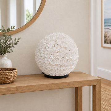 White Daisy shell table lamp switched off on a natural timber hallway console in a coastal entryway