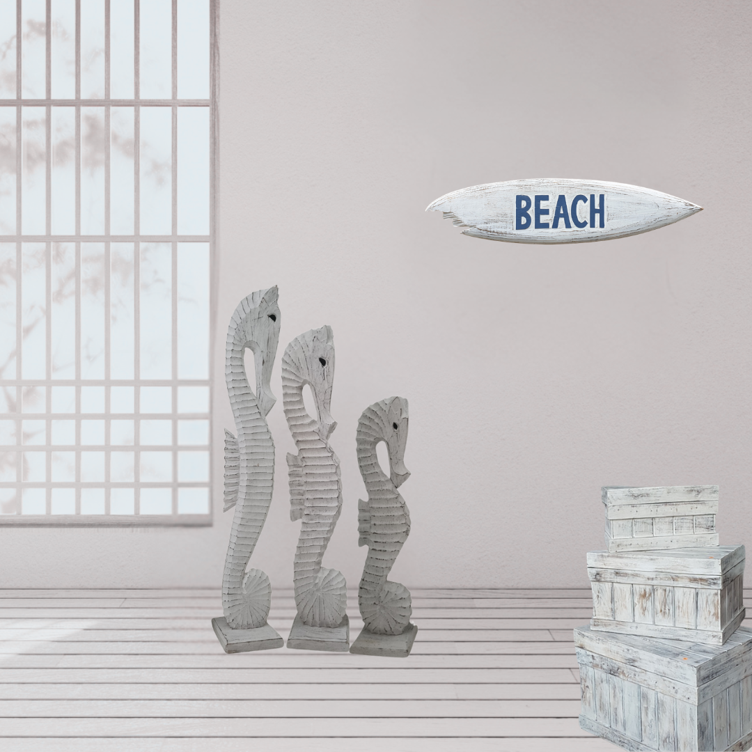 Decorative seahorse statues and a 'BEACH' sign in a room with a window.