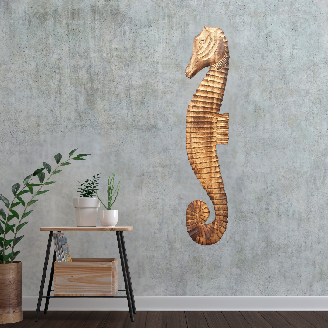 Wooden seahorse wall decor on a textured wall with a small table and plants below.
