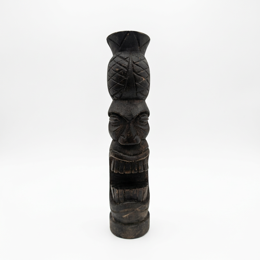 Dark wooden tiki totem with a pineapple-style carved top and an open toothy mouth, standing on a white background.