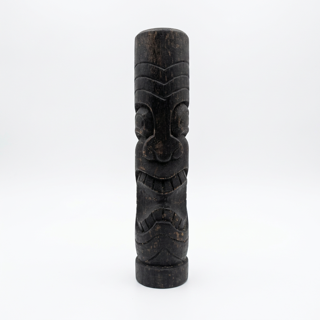 Dark timber carving with V-shaped forehead grooves, rounded eyes and a toothy smile, standing on a white background