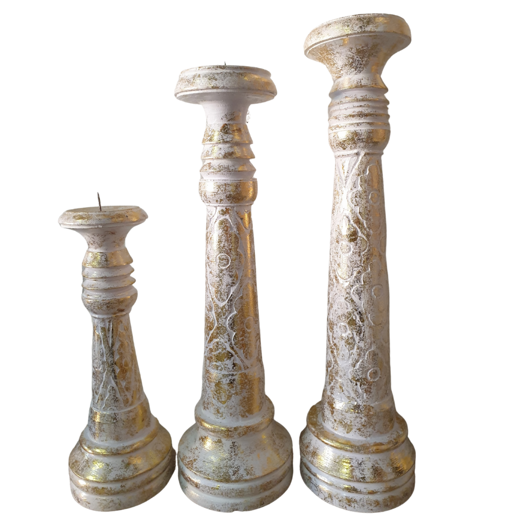 a set of goldwash candle holders in 3 different sizes 