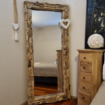 Large rectangular driftwood wall mirror leaning vertically in a coastal boho bedroom beside a timber dresser — chunky mosaic natural driftwood frame, 80x180cm — handcrafted wall mirror by Azure Decor