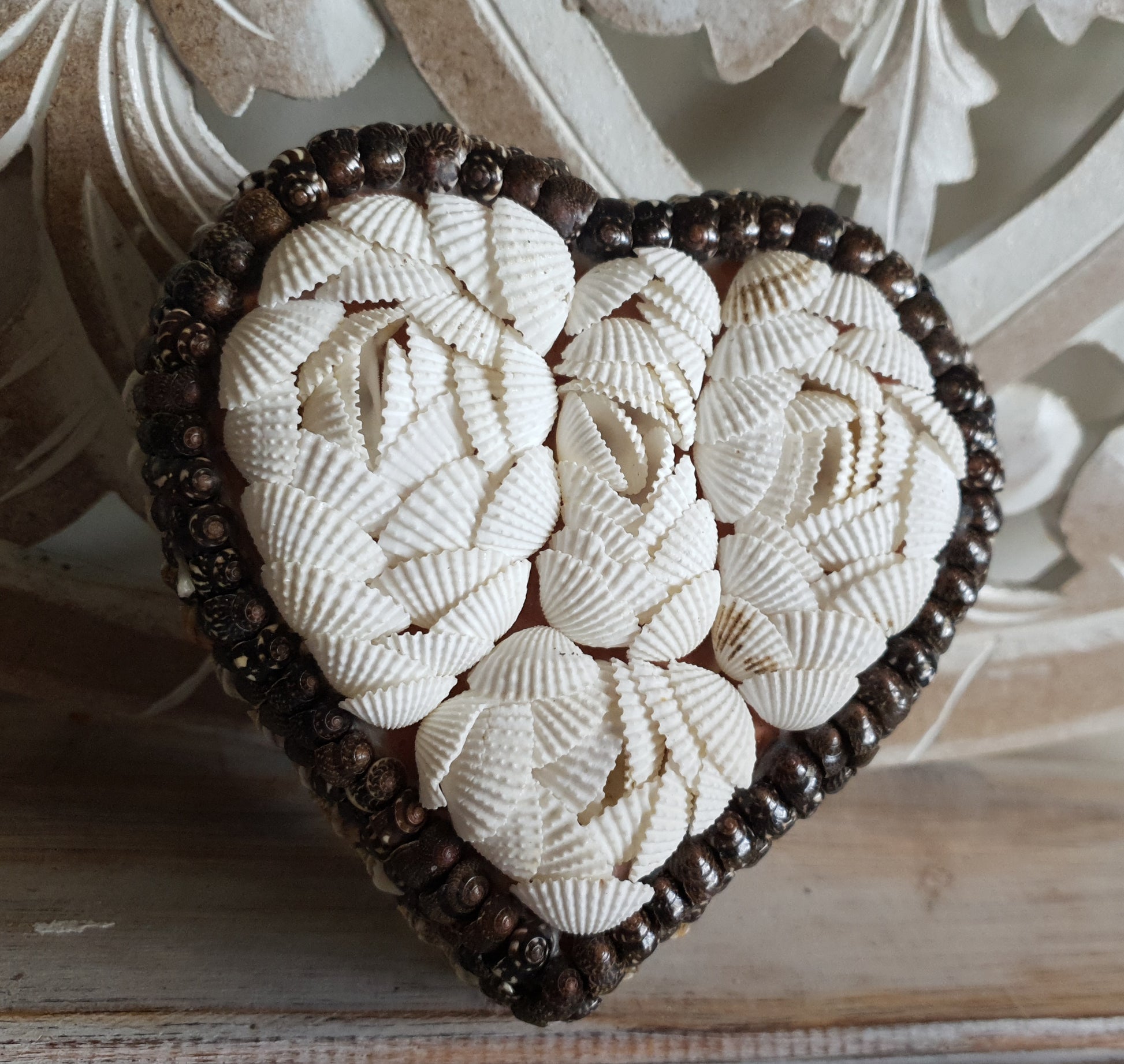 Medium heart-shaped shell trinket box on a dresser tabletop