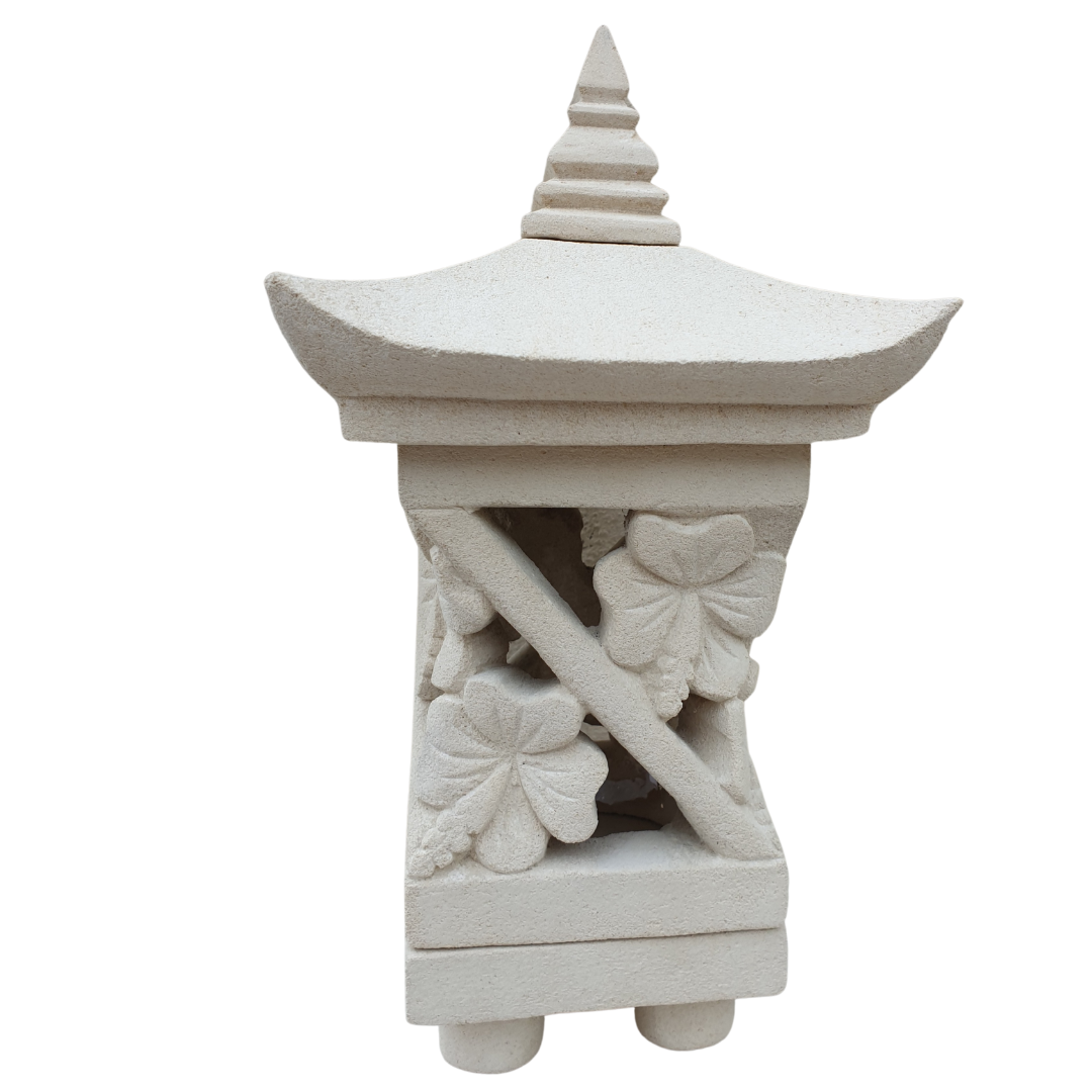 Hand-carved stone pagoda lantern with hibiscus carvings on white background