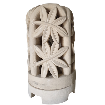 Decorative limestone lantern with fern designs on a white background