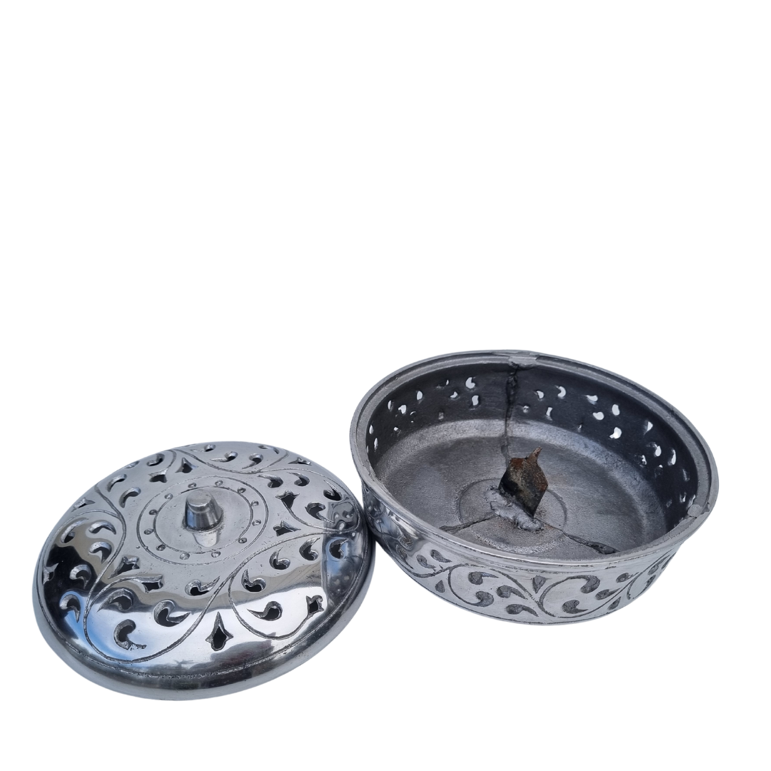 open silver: Open silver bowl showing the central support, with its decorative pierced lid resting to the left on a white background