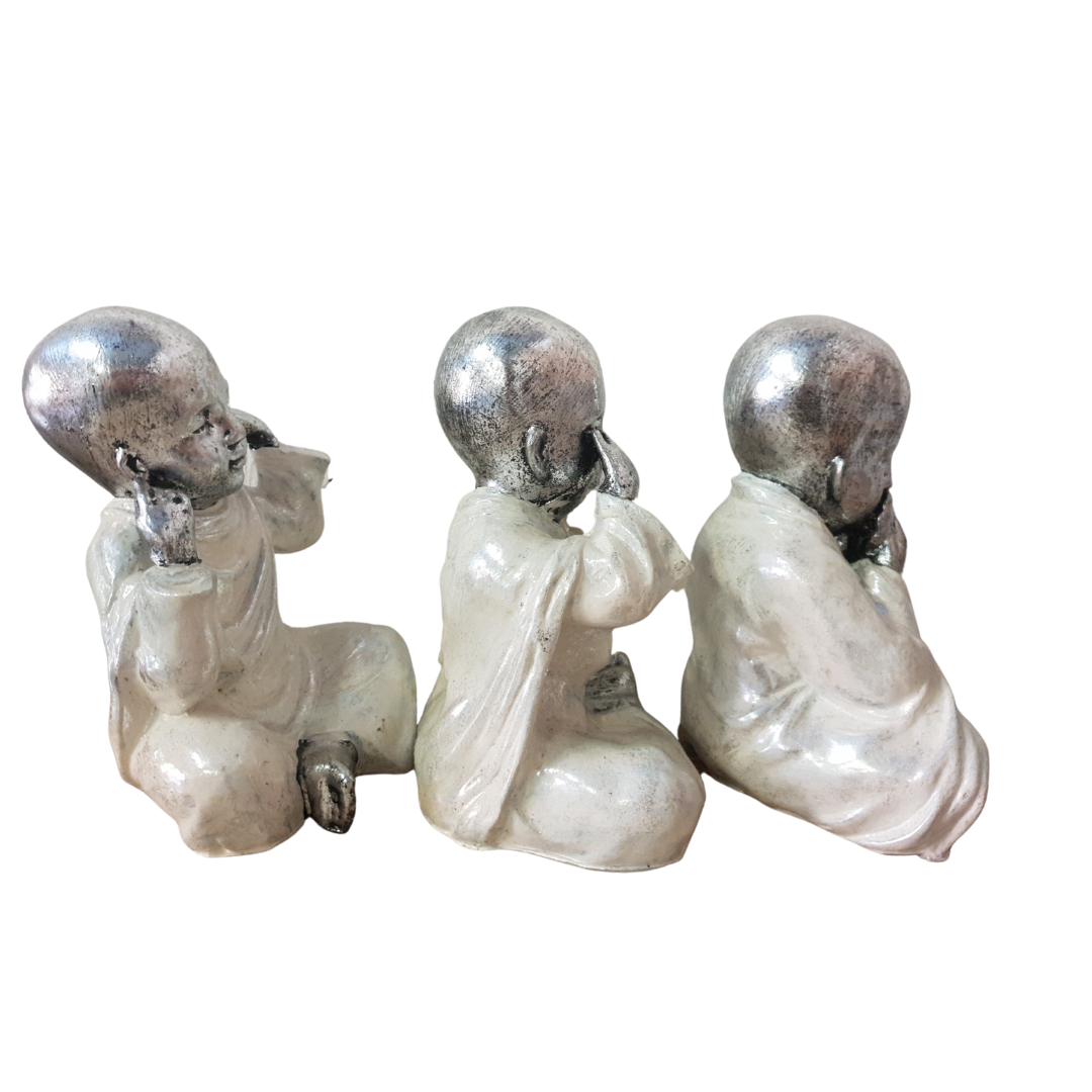 Three Wise Buddha Statues side view