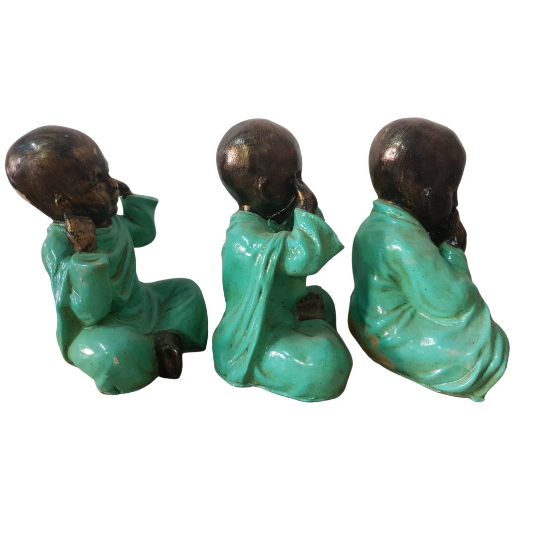 Three Wise Buddha Statues side view