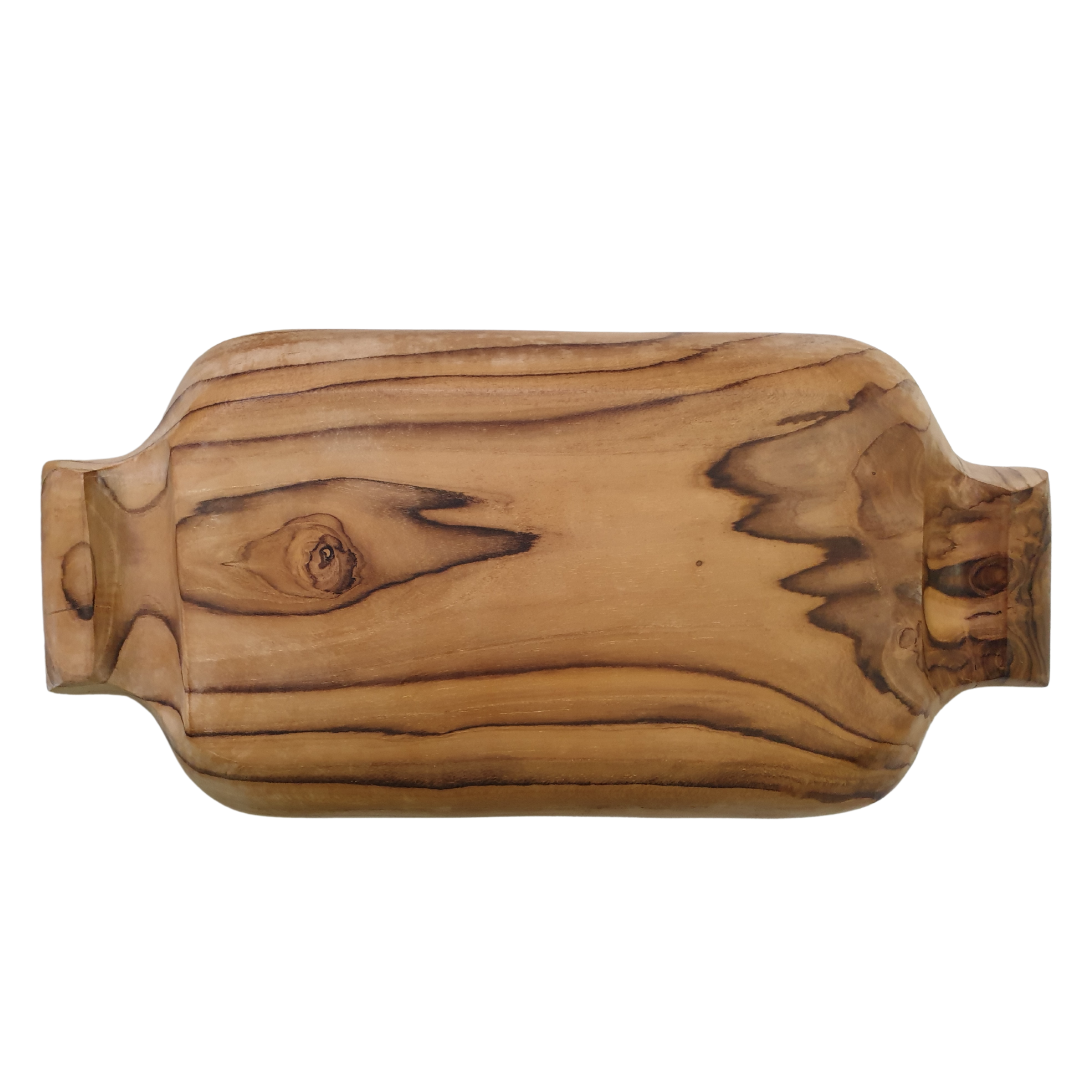 Overhead view of a hand-carved showing natural wood knot and flowing grain lines across a pale teak surface