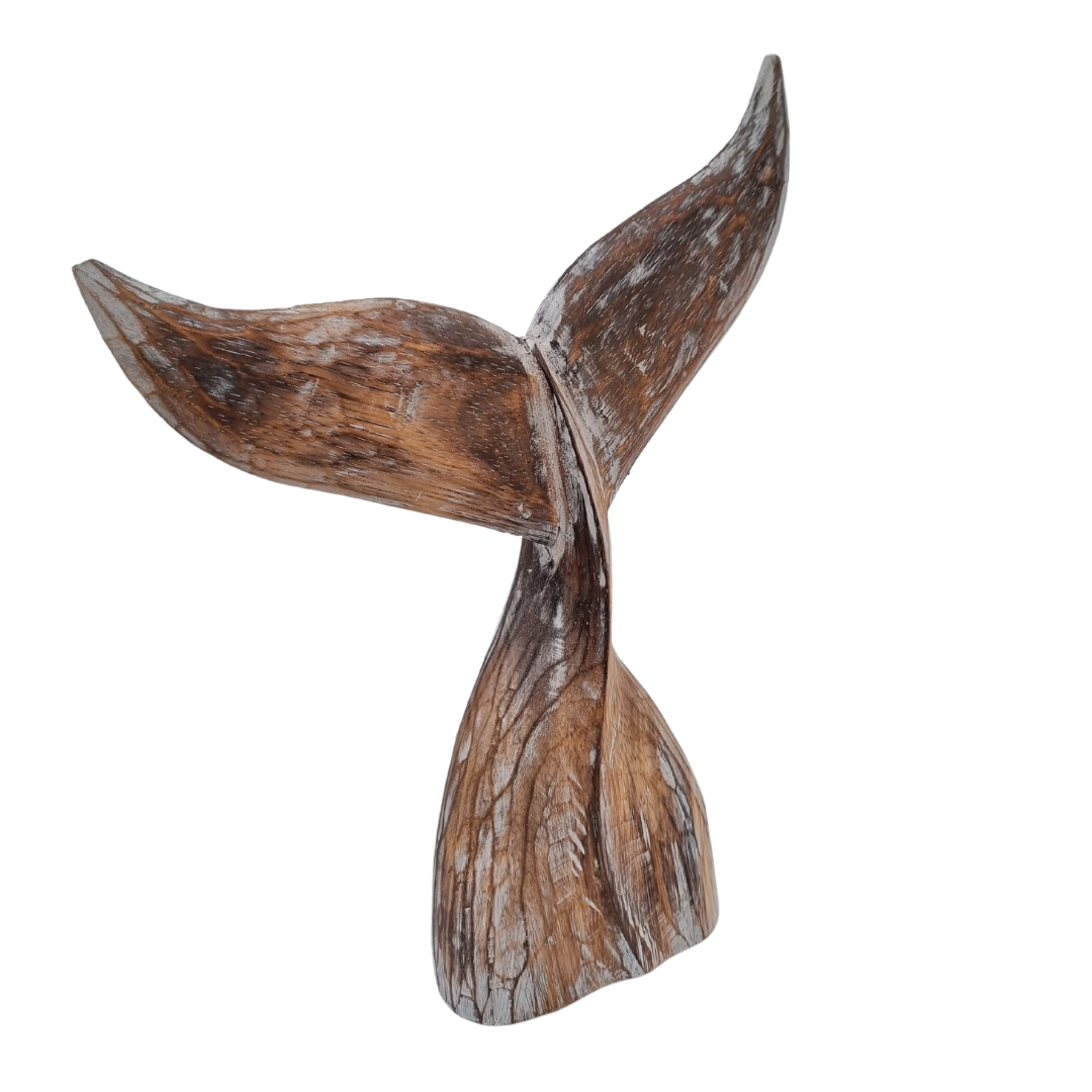 A handcrafted wooden carving of a whale tail with natural brown wash  wood color 
