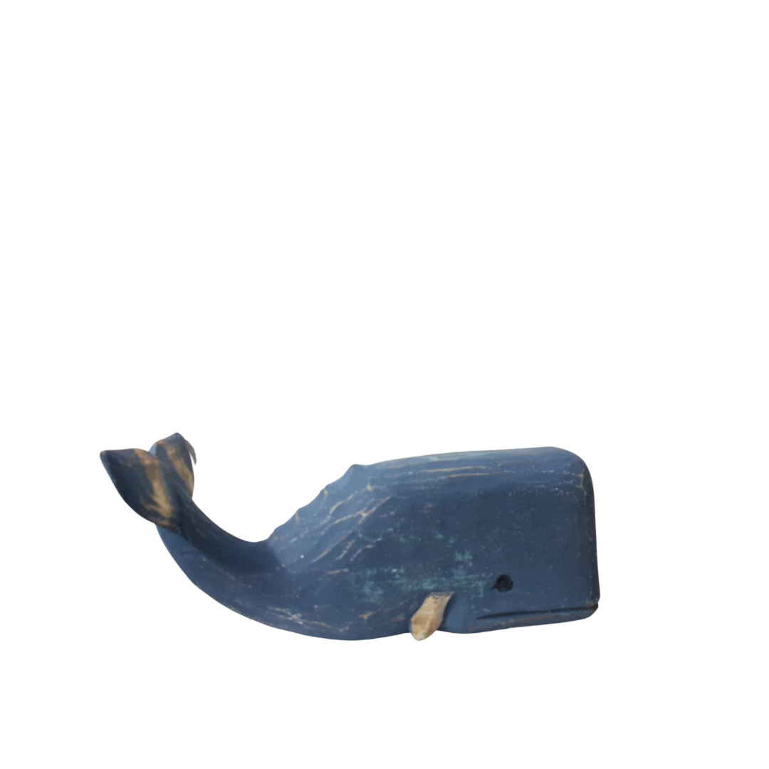 A wooden carved whale decoration in deep blue color with a rustic finish.