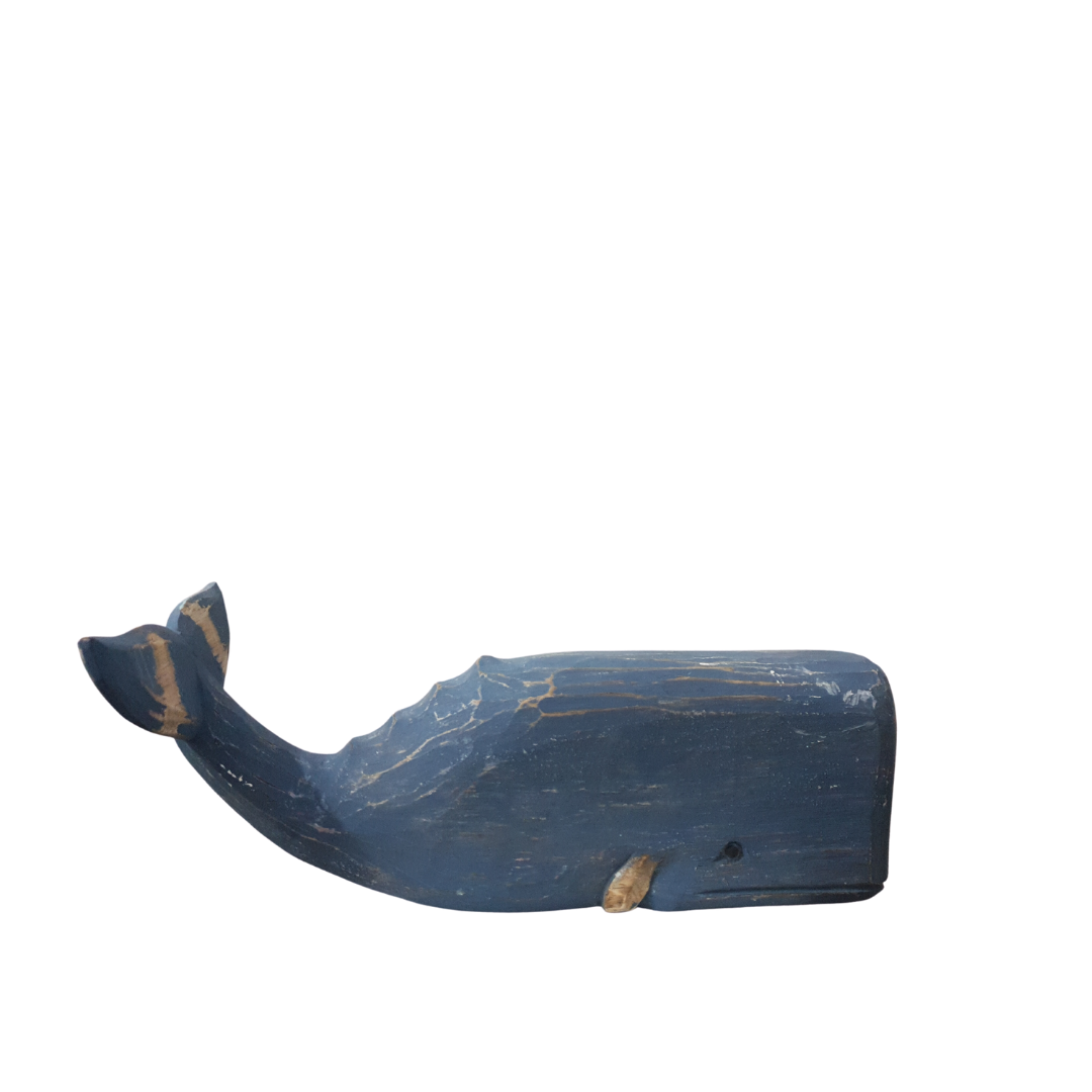 A wooden carved whale decoration in blue color with a rustic finish.