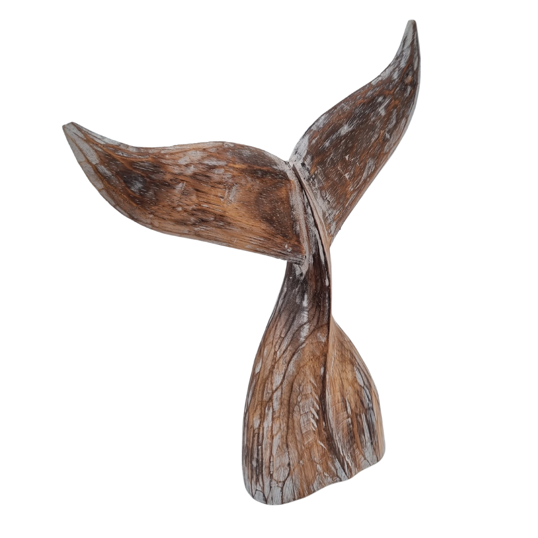 A handcrafted wooden carving of a whale tail with natural brown wash finish wood color